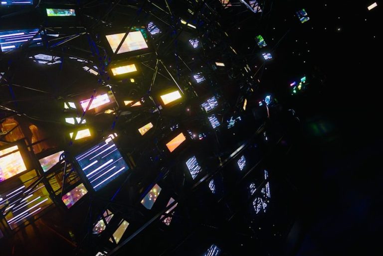 Abstract network of glowing screens in darkness