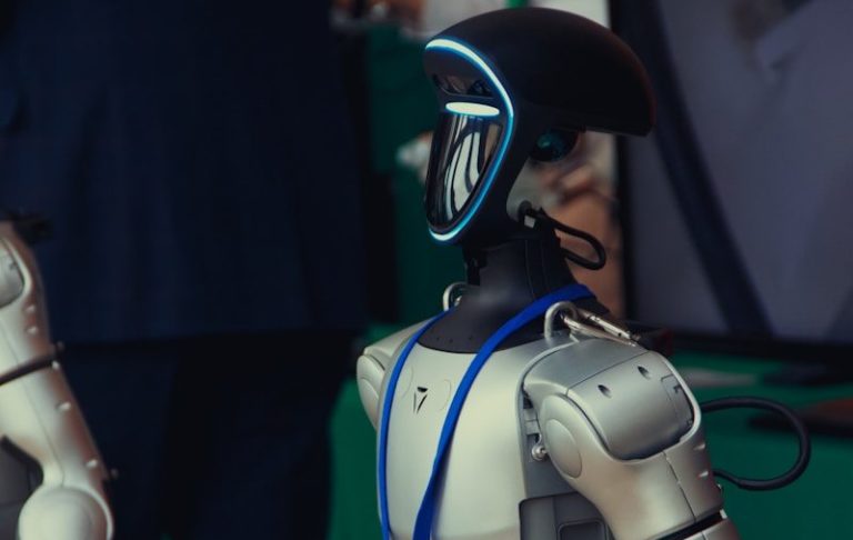 A humanoid robot with a blue lanyard and badge.