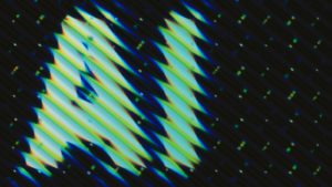 Abstract pattern of slanted lines and dots.