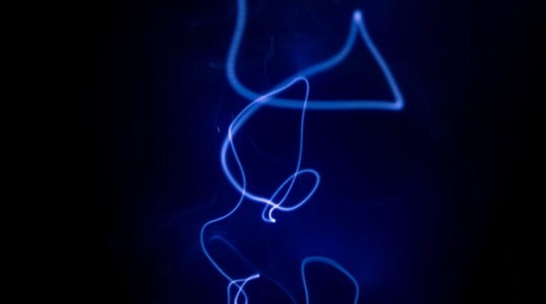 a blue light is shining on a black background