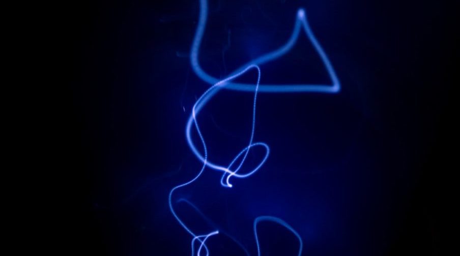 a blue light is shining on a black background