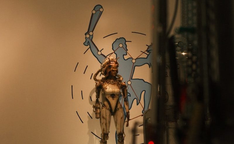 Sculpture of a futuristic warrior with a bat silhouette.