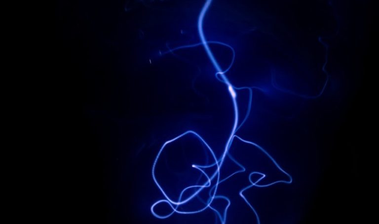 a black background with a blue light in the dark