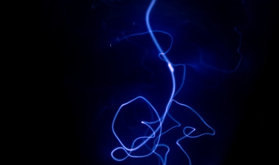 a black background with a blue light in the dark