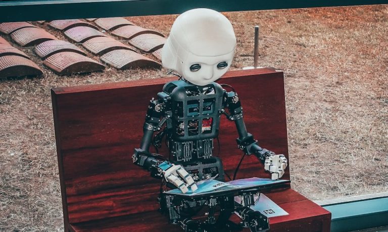 black and white robot toy on red wooden table